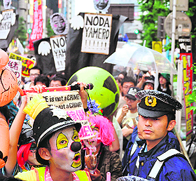 Anti-nuclear activists hold placards during a demonstration in Tokyo on Sunday.