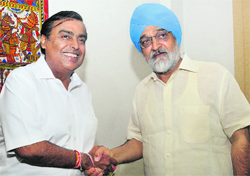 Reliance Industries Chairman Mukesh Ambani shakes hands with Deputy Chairman of Planning Commission Montek Singh Ahluwalia in New Delhi on Monday. 