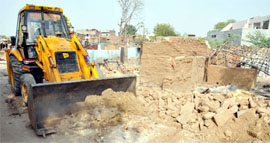 Encroachments being demolished from near Alankar Cinema on GT Road.