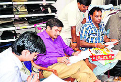Officials of the Food and Civil Supplies Department check packed food items at Vishal Mega Mart in Haridwar on Monday