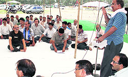 Members of the Diploma Engineers Association stage a dharna in support of their demands at the Parade Ground in Dehradun on Monday