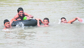 Children take a dip in a canal to beat the heat in Karnal.
