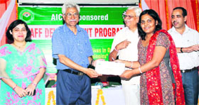 Prof AK Madan gives away a certificate to a participant during a function at JCD College of Pharmacy in Sirsa.