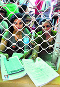 Pilgrims queue up for registration at the base camp at Bhagwati Nagar in Jammu on Monday