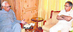 Governor NN Vohra discusses a point with Agriculture Minister Ghulam Hassan Mir in Srinagar on Monday