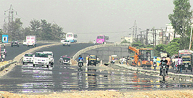 An approach road to a flyover on GT Road gleams due to the mirage effect on a hot Monday afternoon in Jalandhar. 