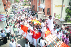 Members of the Kashmiri Pandit community take Pandit Amarnath Vaishnavis body in a procession in Jammu on Monday. 