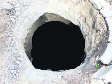 An open manhole on the Disposal road in Jagraon. 