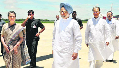 Prime Minister Manmohan Singh and UPA chairperson Sonia Gandhi with Assam CM Tarun Gogoi after their arrival at the airport in Jorhat on Monday for an aerial survey of flood-affected areas in the state.