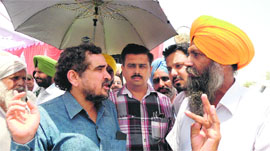 Dr Mihir Shah of the Planning Commission speaks with a farmer at Sikhwala village in Lambi constituency; and (right) members of the central team at a site where efforts are afoot to drain out water.