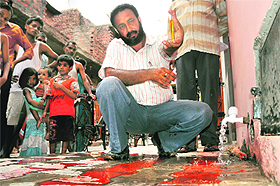 An official of the health department takes a water sample from Vikas Nagar in Chandigarh on Tuesday.