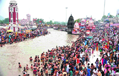 Devotees take a dip at Brahamkund, Har-ki-Pauri, on the occasion of Guru Poornima in Haridwar on Tuesday.