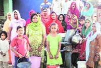 People with empty buckets at Suhala village in Palampur