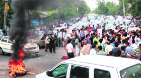 Protesters burn tyres and block a road in protest against the shortage of water and power in Gurgaon on Tuesday. 