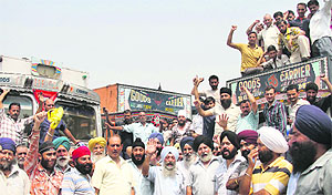 Members of the All-Jammu and Kashmir Oil Tanker Drivers and Cleaners Union hold a protest in Jammu on Tuesday