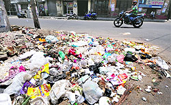 Heaps of garbage near Kailash Cinema Chowk in Ludhiana on Tuesday