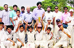 Players of the Prof FC Chopra XI strike a pose with their trophy in Ludhiana on Tuesday