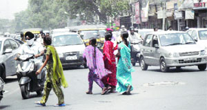 In the absence of zebra crossings and subways, pedestrians find it extremely risky to cross roads amidst heavy traffic in Amritsar.