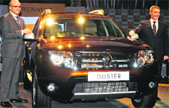 Renault India MD Marc Nassif (L) and VP (sales & marketing) Len Curran pose with the French auto majors Duster SUV at its launch in New Delhi on Wednesday. The vehicle, which comes in 8 variants with petrol or diesel engines, has been priced between Rs 7.19 lakh and Rs 11.29 lakh.  Tribune photo by Manas Ranjan Bhui