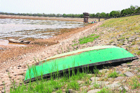 An overturned boat lying on the bed of Sukhna Lake in Chandigarh on Wednesday.
