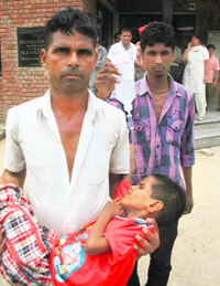 A child suffering from diarrhoea being taken to hospital.