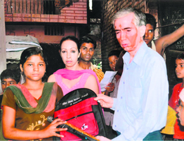An SBI official gives schoolbags to children at a function in Dehradun.