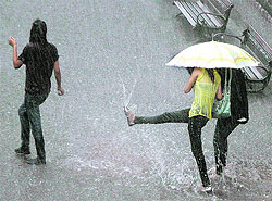 Girls enjoy during heavy rain in Shimla on Wednesday