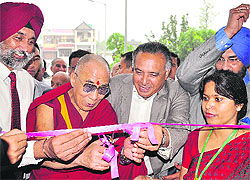 The Dalai Lama, flanked by Col Harinder S Chahal, Zonal Director, Fortis Healthcare, and MLA GS Bali, inaugurates the Fortis Hospital in Kangra on Wednesday