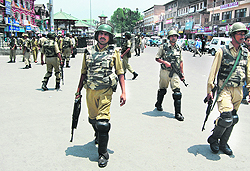 Armed troopers stand guard in Srinagar.