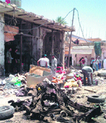 Iraqis inspect damages following a car bombing in Zubaidiyah.  AFP