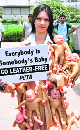 A People for the Ethical Treatment of Animals (PETA) activist during a protest against leather goods at the ongoing India International Leather Fair 2012 in New Delhi on Thursday.  Tribune photo by Mukesh Aggarwal