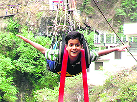 A teenager enjoys a ride on Flying Fox near Kempty Falls in Mussoorie.