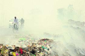 Smoke emanates from the garbage being burnt outside the solid waste management plant near Sekhpura Suhana village on the Karnal-Meerut road in Karnal