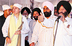 Chief Minister Omar Abdullah receives a kirpan from a group of Sikhs at Gurdwara Chatti Padshahi in Srinagar as the 417th birth anniversary of Guru Hargobind was celebrated with religious fervour and gaiety on Thursday