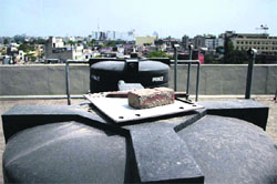 A metal sheet being used to cover a water tank on the terrace of the Municipal Corporation office in Jalandhar. 