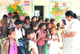 A teacher interacts with children who will be studying at the newly opened NCLP school at Mithapur in Jalandhar on Friday.