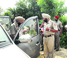 The police takes out the bodies of a couple from a car in Jagraon on Thursday. 