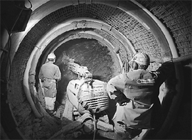 Workers excavate a tunnel for a new experiment in the Mont Terri rock laboratory, a research project of the Swiss Federal Office of Topography, in St-Ursanne, Western Switzerland. The Mont Terri Project is an international research project on the hydrogeological, geochemical and geotechnical characterisation of a clay formation. Clay formations are being considered in various countries for the deep geological disposal of radioactive waste and is the only host rock being proposed in Switzerland. The rock laboratory is dedicated solely to research, as such no radioactive waste is disposed here.