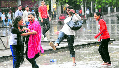 Mirthful: Girls enjoy the first splash of monsoon rain in Sector 17, Chandigarh, on Friday. 