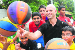 Troy Justice, director, NBA, shares a light moment with budding players at New Public School courts, Sector 18, Chandigarh, on Friday.
