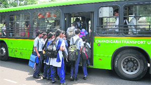 Students of Government Model Senior Secondary School, Sector 16, Chandigarh, board a CTU bus in front of their school. 