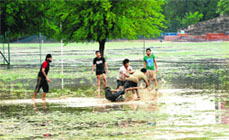 Panjab University students play kabaddi at a water-logged playground after heavy rain in Chandigarh on Friday. 