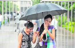 Girls enjoy the rain in Jalandhar on Friday.
