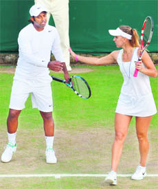 Indias Leander Paes and Russias Elena Vesnina (R) during their quarterfinal match against Australia's Paul Hanley and Russia's Alla Kudryavtseva in Wimbledon on Friday. 