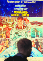 A man walks past a poster for the Bond film Moonraker.  AFP
