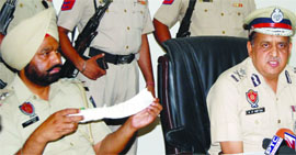 A police official shows the weapon used in the crime.