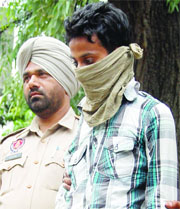 Accused Ravi Kumar in the police custody in Amrtisar on Saturday.