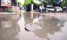 Even as the storm water sewer system has been installed near the gate of the DC office, a manhole cover had to be partially opened to drain out the rainwater in Jalandhar on Saturday