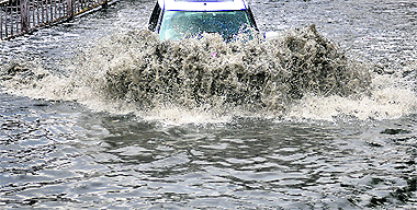 A car wades through a waterlogged road in Ludhiana on Saturday. 