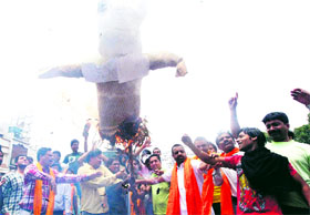 Activists of Rashtrawadi Shiv Sena burn an effigy of yoga guru Ramdev in protest against his support to the SGPC on Operation Bluestar Memorial in Amritsar on Sunday.